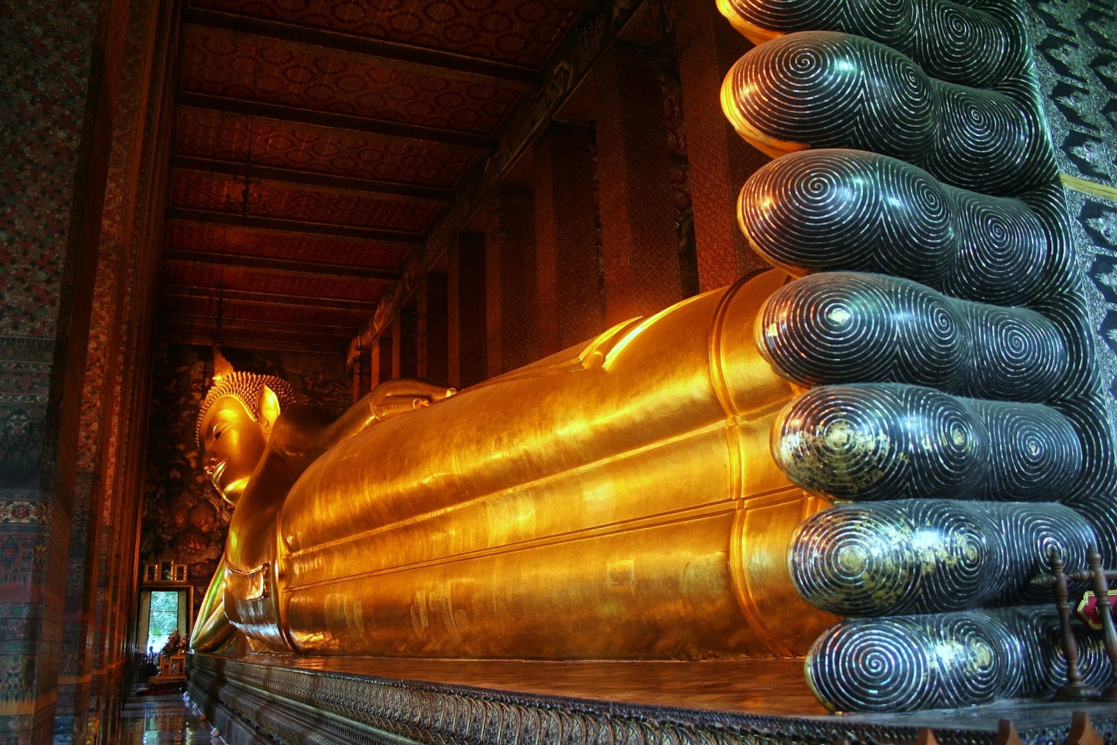 The Reclining Buddha seen from the feet end, with dark mother-of-pearl soles