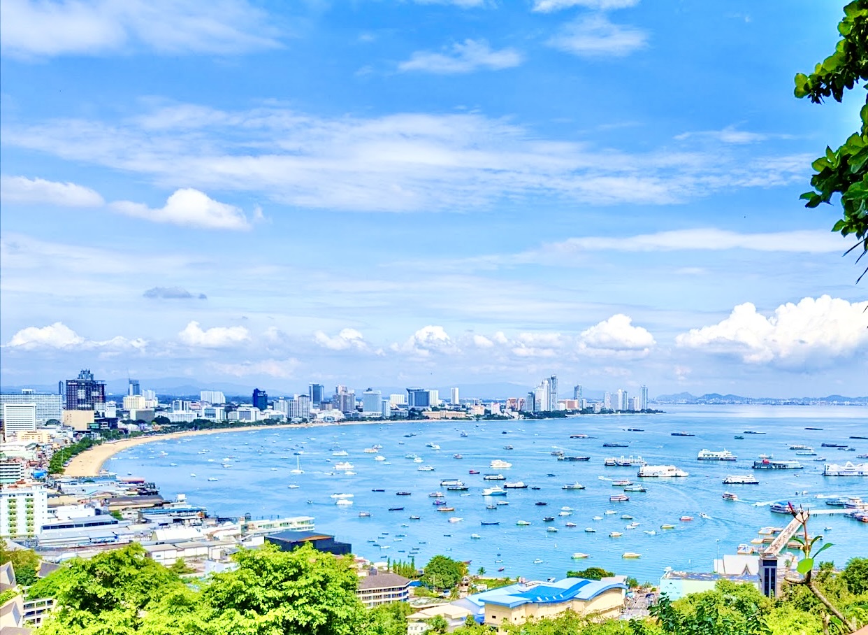 View over Pattaya Bay with boats moored off the city beach and high-rises behind
