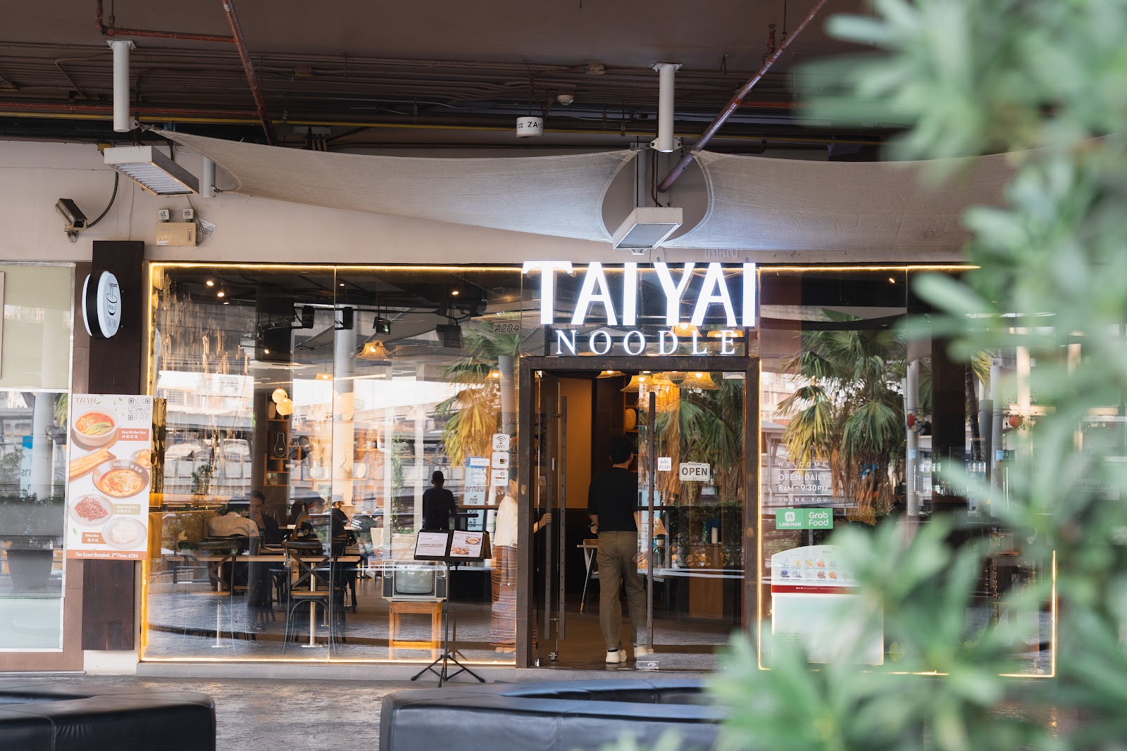 Tai Yai Noodle shopfront with its illuminated sign inside The Coast Bangkok