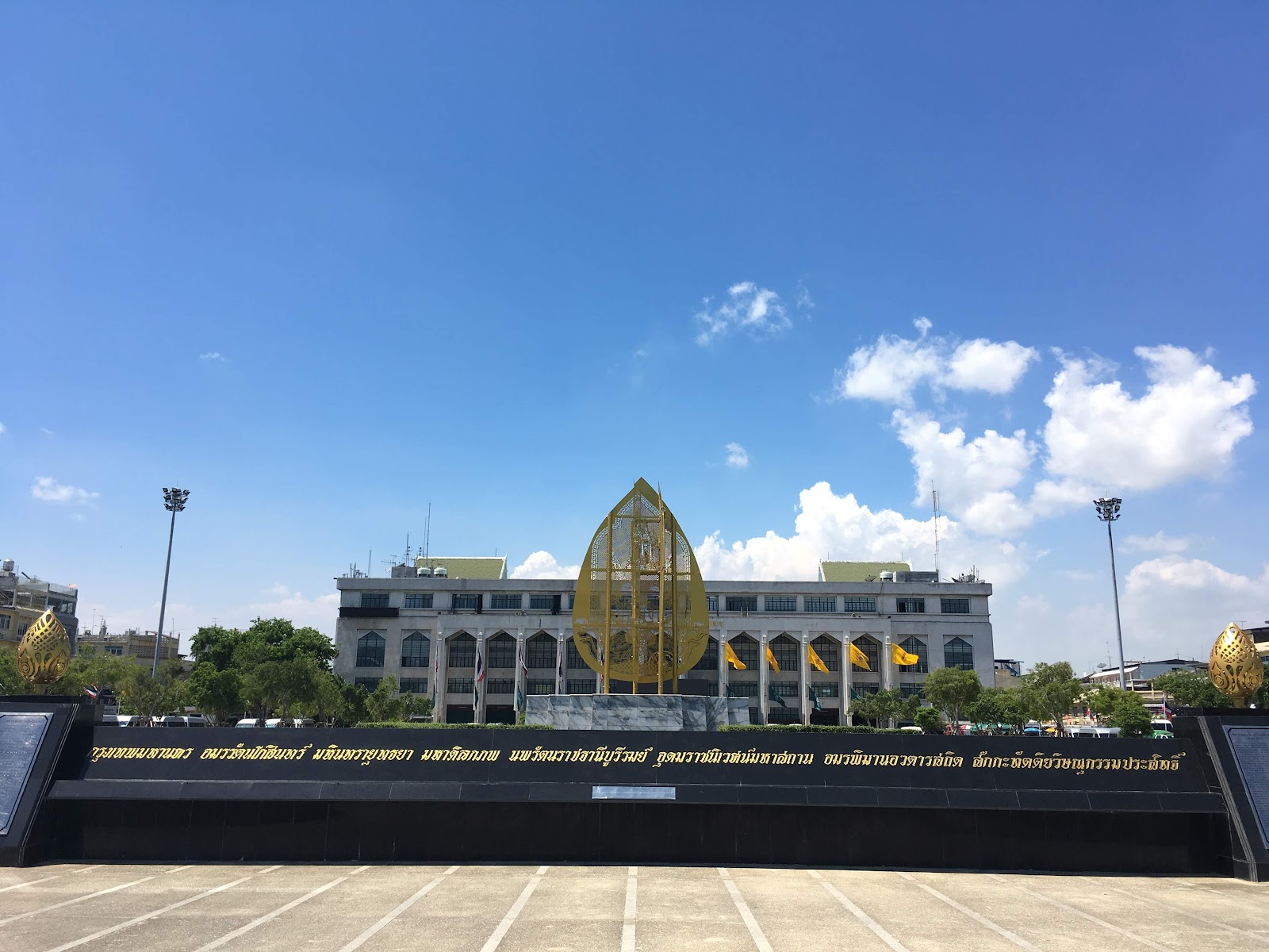 Bangkok City Hall behind a long black wall inscribed in gold Thai lettering