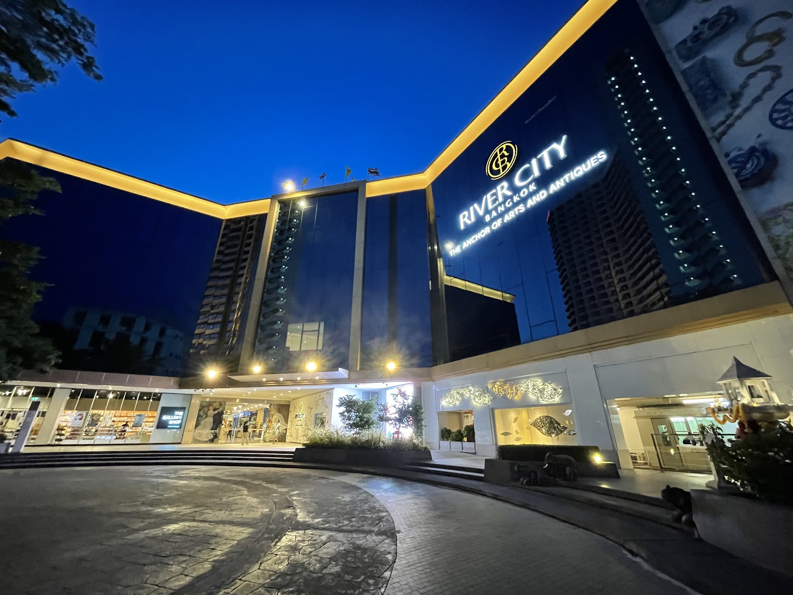 River City Bangkok building lit up at night with its illuminated sign