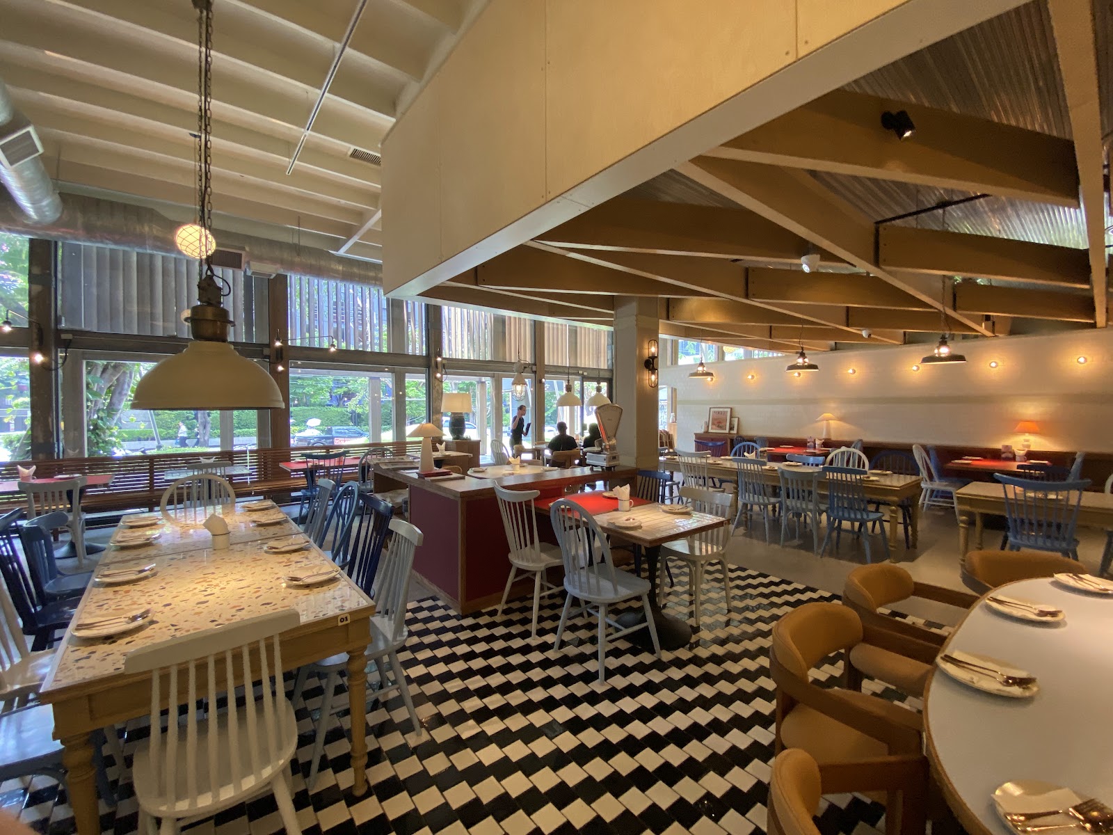Dining room of Laem Charoen Seafood Ekkamai with checkered floor and wooden ceiling