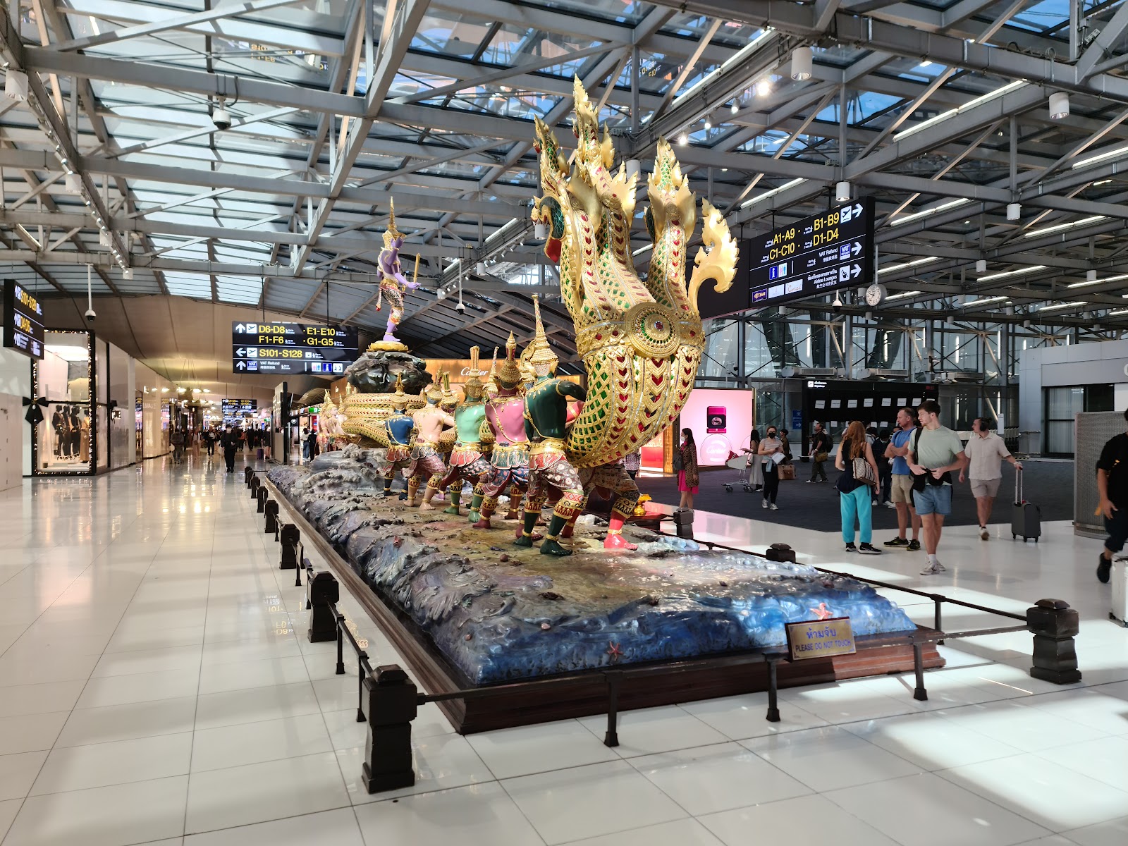 The large Churning of the Milk Ocean sculpture with a many-headed naga in the Suvarnabhumi departure hall