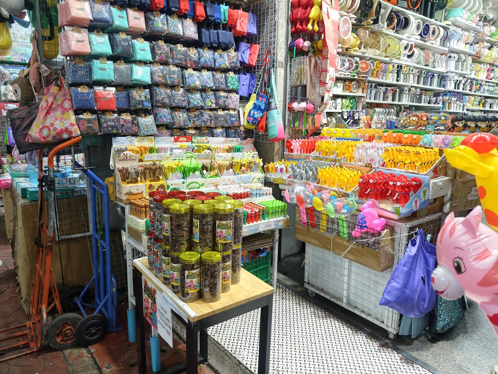 Wholesale stalls stacked with small goods and toys in Sampheng market
